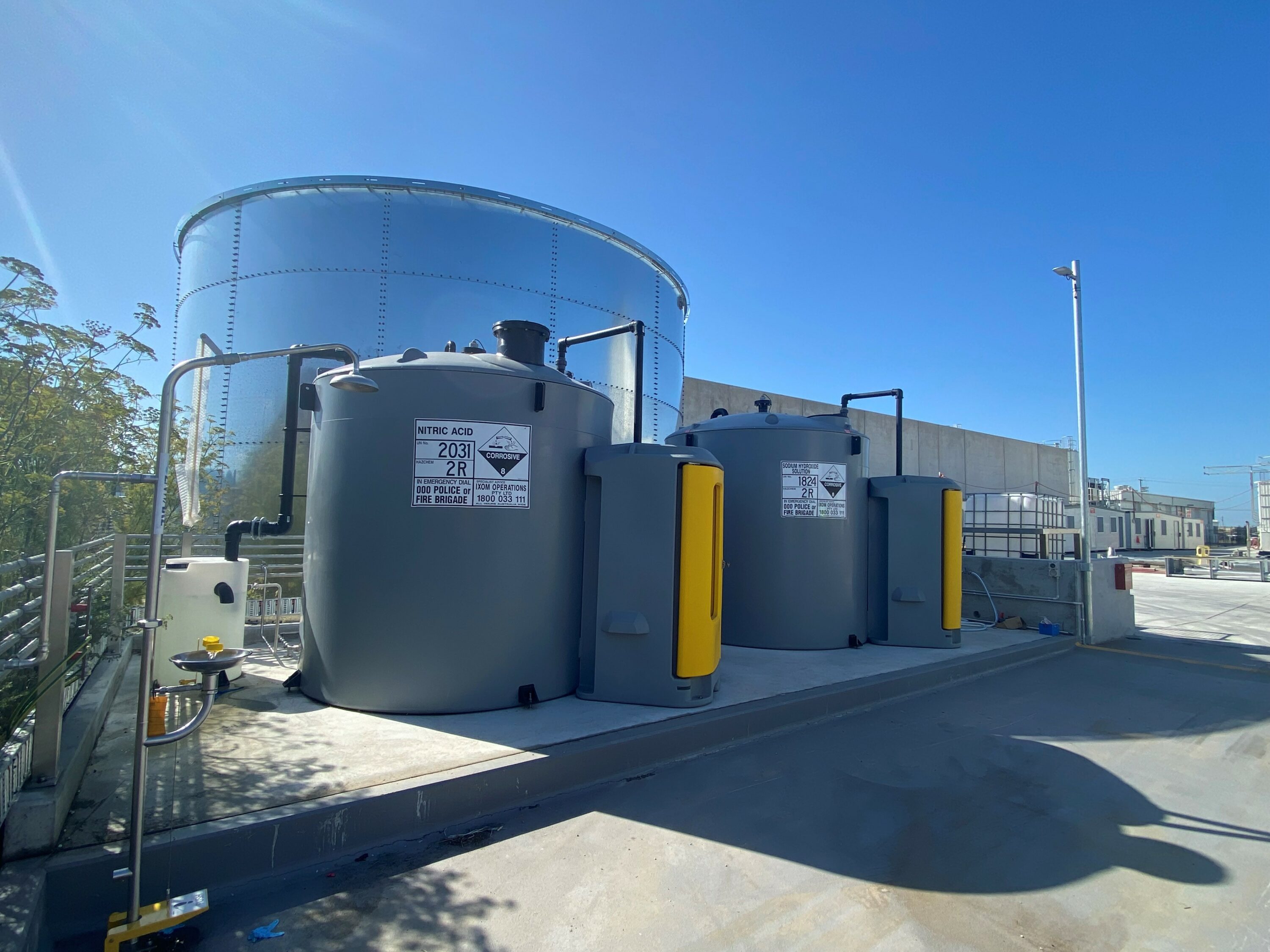 Two large tanks on the side of a building.