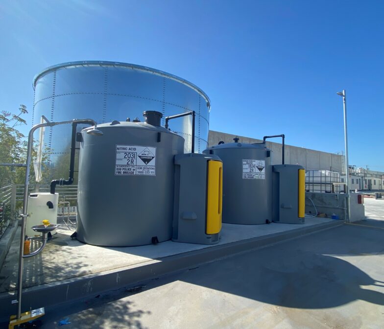 Two large tanks on the side of a building.