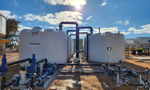Polymaster large-capacity industrial chemical storage tanks with pipe manifold system installed at a lithium mining processing facility in outback Australia