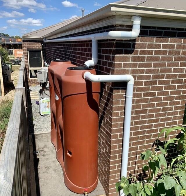 Slimline tank beside house