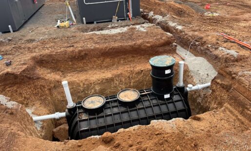 Underground Polymaster plumbing installation connected to a buried water system at a construction site