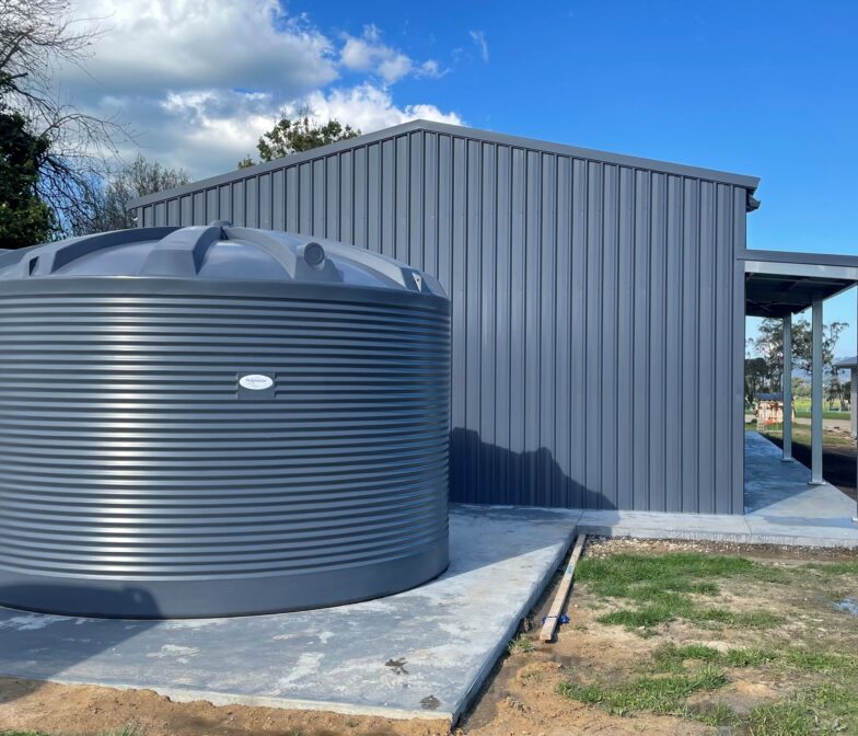 Poly water tank beside shed