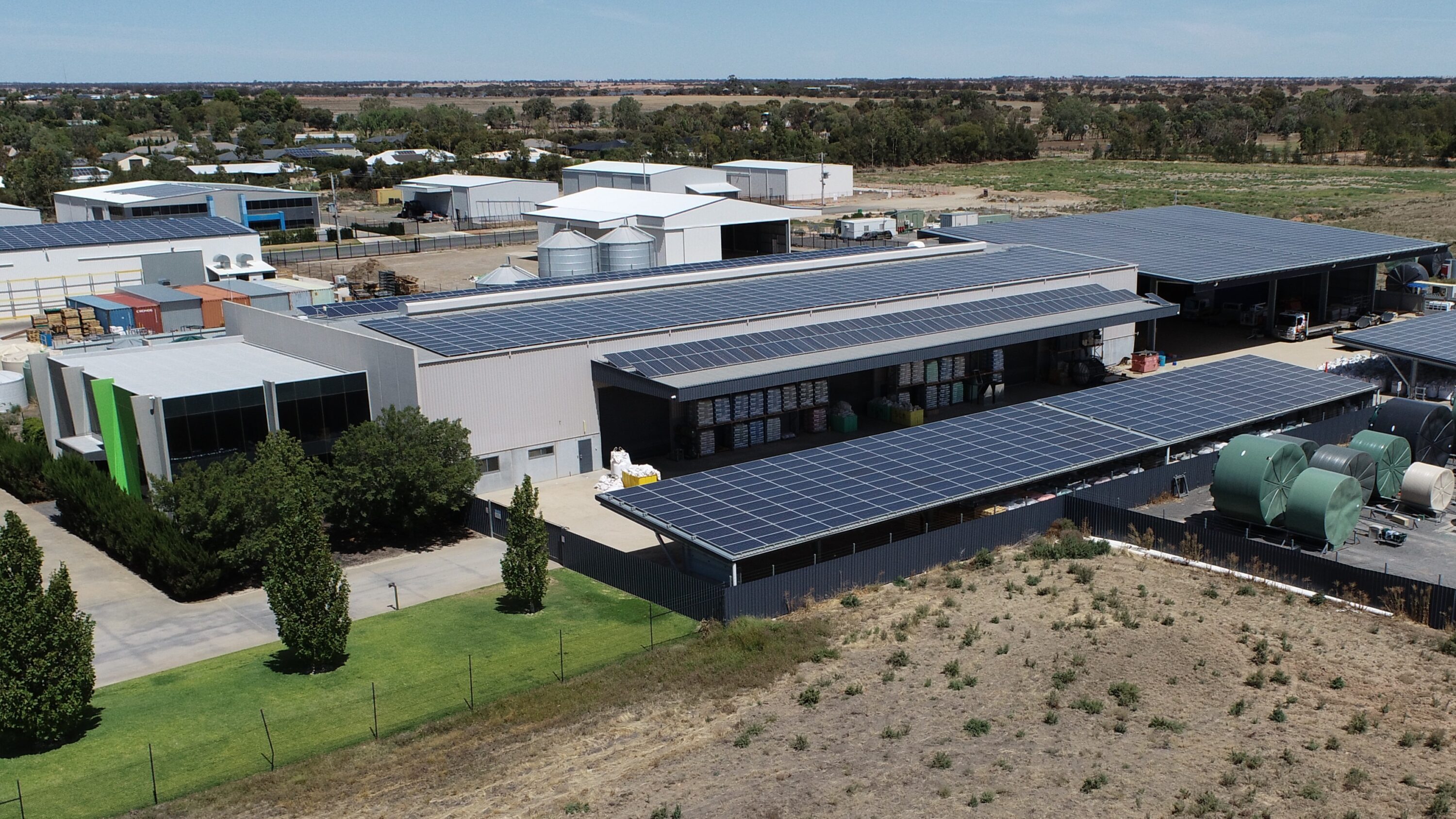 Aerial view of the Polymaster manufacturing facility with rooftop solar panels and water tanks on site