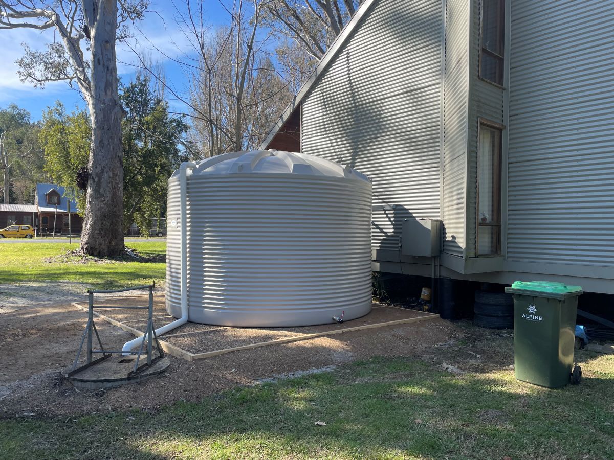 round tank beside house