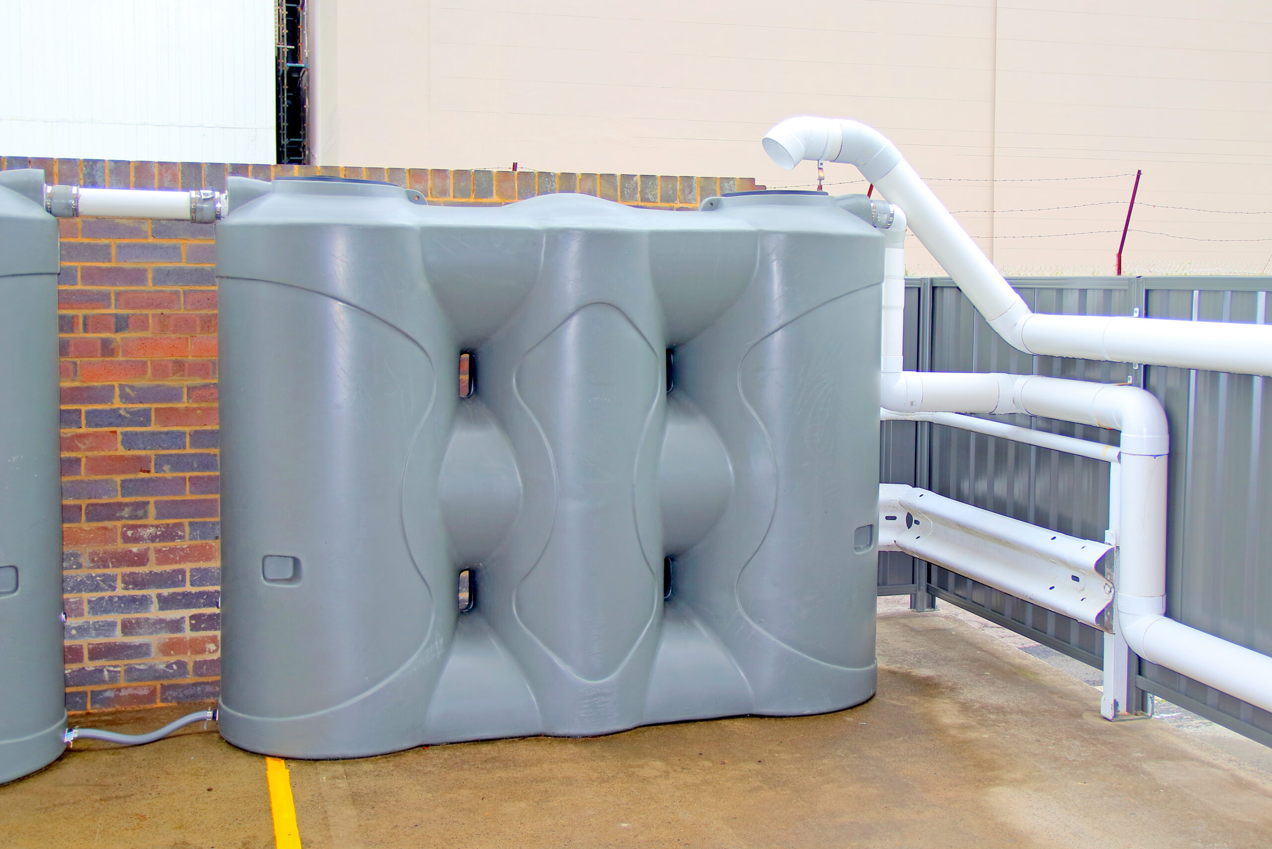 Polymaster slimline water tank plumbed in building laneway