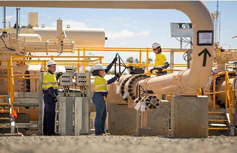 Engineers and workers in yellow vest in an industrial workplace
