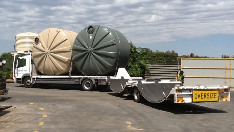 Two water tanks loaded in a ten-wheeler delivery truck