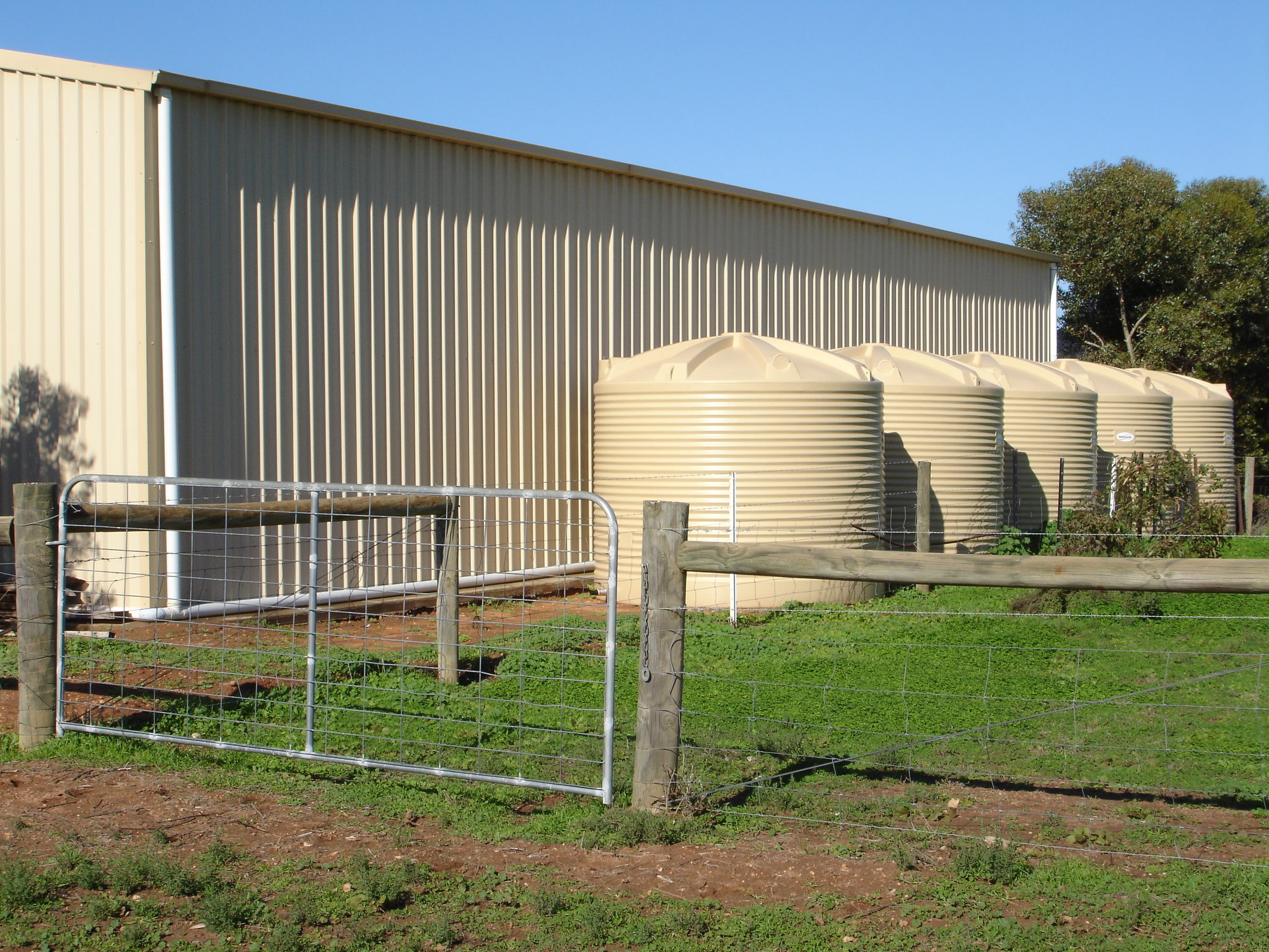 round tanks beside shed